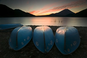 Boats on shore of Lake Motosu with Mount Fuji in background Boats on shore of Lake Motosu with Mount Fuji in background