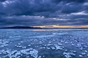 Chunks of ice lying on icy surface on the shore of Reichenau Island, Baden-Wuerttemberg, Germany, Europe Chunks of ice lying on icy surface on the shore of Reichenau Island, Baden-Wuerttemberg, Germany, Europe