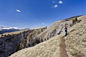 Climber at the end of the Stevia climbing route in Vallunga near Selva, overlooking Sciliar Mountain, Val Gardena Climber at the end of the Stevia climbing route in Vallunga near Selva, overlooking Sciliar Mountain, Val Gardena