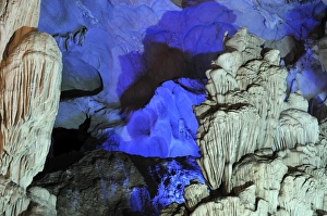 Colourfully, illuminated rock formation in Hang Sung Sot cave, Surprise Cave, Cave of Awe Colourfully, illuminated rock formation in Hang Sung Sot cave, Surprise Cave, Cave of Awe