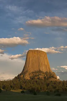 Columnar basalt formations with clouds at sunset, Devils Tower National Monument, Wyoming, USA Columnar basalt formations with clouds at sunset, Devils Tower National Monument, Wyoming, USA