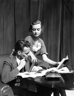 Couple At A Desk With Check Books Papers Balance Books & Inkwell The Woman Wearing A Couple At A Desk With Check Books Papers Balance Books & Inkwell The Woman Wearing A