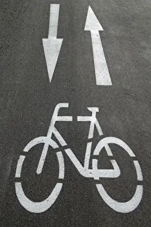 Asphalt Road Markings Prints: Cycle path, directional arrows, road markings on the asphalt