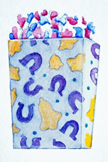Decorated cardboard box heaped with colourful confetti Decorated cardboard box heaped with colourful confetti