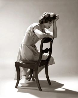 Depressed Sad Moody Woman Leaning Head Onto Arm Slouched Lean Back Of Chair Seated Depressed Sad Moody Woman Leaning Head Onto Arm Slouched Lean Back Of Chair Seated