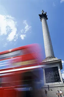 Double Decker Bus Driving past Nelsons Column on Trafalgar Square Double Decker Bus Driving past Nelsons Column on Trafalgar Square