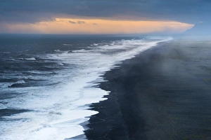 Dramatic clouds, black sandy beach near Dyrholaey, south coast, Southern Region, Iceland Dramatic clouds, black sandy beach near Dyrholaey, south coast, Southern Region, Iceland