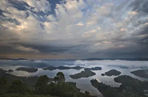Dramatic clouds and fog at sunrise above the islands of Bunyonyi Lake, Kisoro Dramatic clouds and fog at sunrise above the islands of Bunyonyi Lake, Kisoro