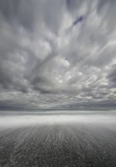 Dramatic clouds above sea and beach, New Zealand Dramatic clouds above sea and beach, New Zealand