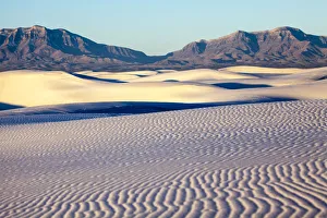 Dunes of White Sands National Monument with rocky mountains in background, New Mexico, USA Dunes of White Sands National Monument with rocky mountains in background, New Mexico, USA