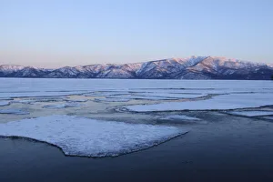 Early morning mood on the frozen Lake Kussharo with ice floes in the front, Akan-Nationalpark, Kawayu Onsen, Hokkaido Early morning mood on the frozen Lake Kussharo with ice floes in the front, Akan-Nationalpark, Kawayu Onsen, Hokkaido