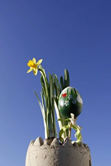 Easter decorations, daffodils and a painted Easter egg Easter decorations, daffodils and a painted Easter egg