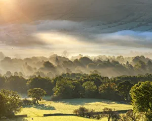 Edale village sunrise with mist and fog and golden light at sunrise. English Peak District. UK Edale village sunrise with mist and fog and golden light at sunrise. English Peak District. UK