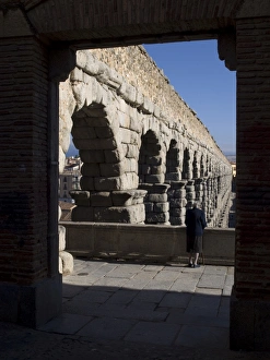 Elderly woman looking at the aqueduct of Segovia Elderly woman looking at the aqueduct of Segovia