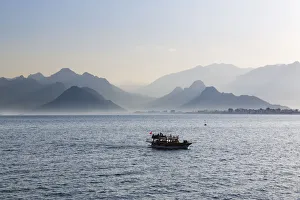 Excursion boat on the sea, in front of the Taurus Mountains, Lycian Taurus, Antalya, Turkish Riviera Excursion boat on the sea, in front of the Taurus Mountains, Lycian Taurus, Antalya, Turkish Riviera