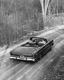 Family driving in convertible along country road Family driving in convertible along country road