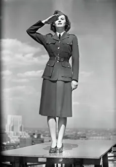 Female soldier standing on table and saluting Female soldier standing on table and saluting
