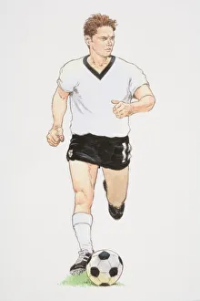 Football player in white T-shirt and black shorts running with football in front of him Football player in white T-shirt and black shorts running with football in front of him