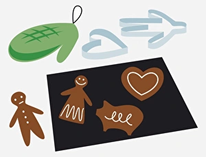 Gingerbread biscuits on baking tray, with oven gloves and shape cutter Gingerbread biscuits on baking tray, with oven gloves and shape cutter