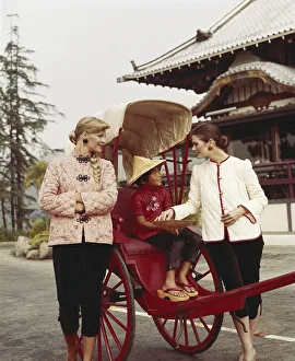 Girl sitting in horsedrawn cart, women standing besides Girl sitting in horsedrawn cart, women standing besides