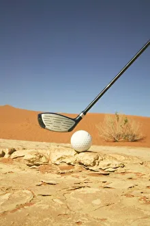 Golf Club and Ball on a Barren Desert Floor Golf Club and Ball on a Barren Desert Floor