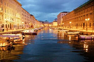 Street art portraits Collection: Grand canal with boats at night in Trieste, Italy