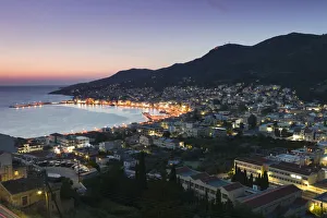 Greece, Samos, Vathy, harbour illuminated at dusk, elevated view Greece, Samos, Vathy, harbour illuminated at dusk, elevated view
