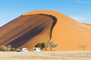 Ground view of the world famous Dune 45 with tourists. Sossuvlei, Namibia Ground view of the world famous Dune 45 with tourists. Sossuvlei, Namibia