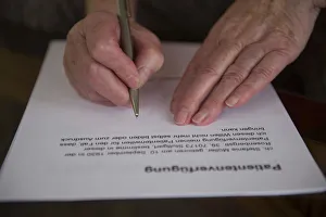 Hands of a 82-year-old woman signing a living will, Germany Hands of a 82-year-old woman signing a living will, Germany