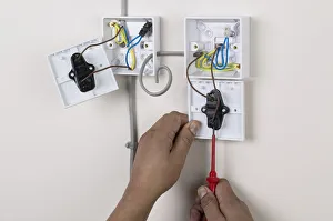 Hands holding screw driver to light switch, face plate off Hands holding screw driver to light switch, face plate off