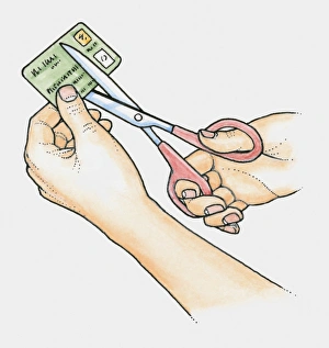 Hands using scissors to cut up an old credit card Hands using scissors to cut up an old credit card