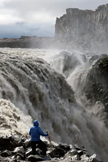 Hiker at Dettifoss Waterfall, Joekulsargljufur, Iceland, Europe Hiker at Dettifoss Waterfall, Joekulsargljufur, Iceland, Europe