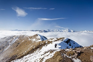 Hikers on Grossen Laugenspitze Mountain above the Laugenalm alpine pasture, looking towards the Ultimo Mountains Hikers on Grossen Laugenspitze Mountain above the Laugenalm alpine pasture, looking towards the Ultimo Mountains