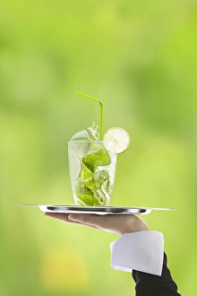 Hugo cocktail with lime and mint being served on a tray Hugo cocktail with lime and mint being served on a tray