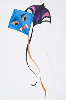 Kite fighting, two colourful kites flying with their lines crossing Kite fighting, two colourful kites flying with their lines crossing