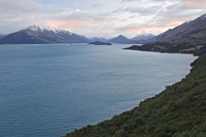Lake Wakatipu in front of a mountain range at sunrise, Otago Region, South Island, New Zealand Lake Wakatipu in front of a mountain range at sunrise, Otago Region, South Island, New Zealand