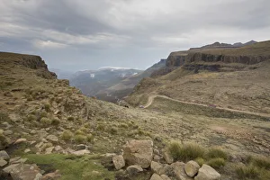 Landscape shot of 4x4 vehicles driving Sani Pass on the border of KwaZulu-Natal Landscape shot of 4x4 vehicles driving Sani Pass on the border of KwaZulu-Natal