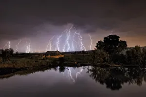 Lightning strikes over abandoned farm house and dam, Magaliesburg, Gauteng Province Lightning strikes over abandoned farm house and dam, Magaliesburg, Gauteng Province