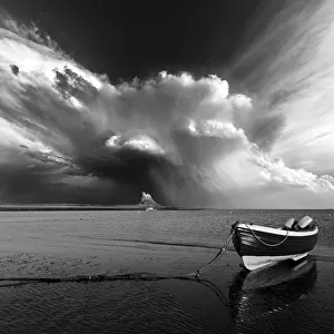 Lindisfarne Castle with a boat and a dramtic stormy sky. Northumberland. UK. Europe Lindisfarne Castle with a boat and a dramtic stormy sky. Northumberland. UK. Europe