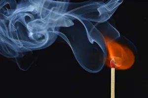 Lit matchstick with a flame and smoke, Germany Lit matchstick with a flame and smoke, Germany