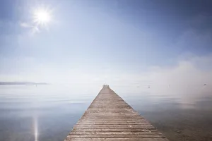 Very long jetty on Chiemsee Lake with high fog and sun near Seebruck, Bavaria, Germany, Europe, PublicGround Very long jetty on Chiemsee Lake with high fog and sun near Seebruck, Bavaria, Germany, Europe, PublicGround