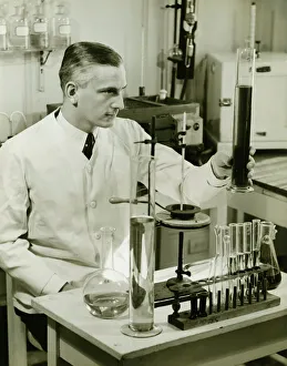 Male pharmacist working with test tubes in laboratory, (B&W) Male pharmacist working with test tubes in laboratory, (B&W)