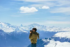 Aletsch Glacier Collection: A Man taking a photo with the background of Alps