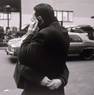 Man talking on cell phone and hugging woman Man talking on cell phone and hugging woman