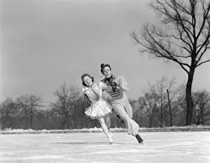 Man Woman Couple Pair Figure Skating On Ice Rink Smiling Costumes Arm In Arm Leaning Precision Glide Dance Man Woman Couple Pair Figure Skating On Ice Rink Smiling Costumes Arm In Arm Leaning Precision Glide Dance