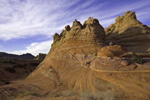 Mature man sitting on sandstone rock, evening Mature man sitting on sandstone rock, evening