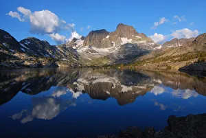 Mirror-like reflections of mighty peaks in an alpine lake Mirror-like reflections of mighty peaks in an alpine lake