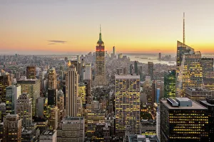 New York City skyline with illuminated skyscrapers seen from above during sunrise, New York State, USA New York City skyline with illuminated skyscrapers seen from above during sunrise, New York State, USA