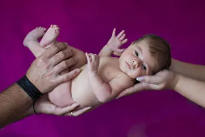 Newborn baby, five days, carried on hands Newborn baby, five days, carried on hands