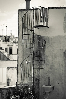 Old cast iron spiral staircase accessing a rooftop terrace in Otranto, Apulia, Italy Old cast iron spiral staircase accessing a rooftop terrace in Otranto, Apulia, Italy